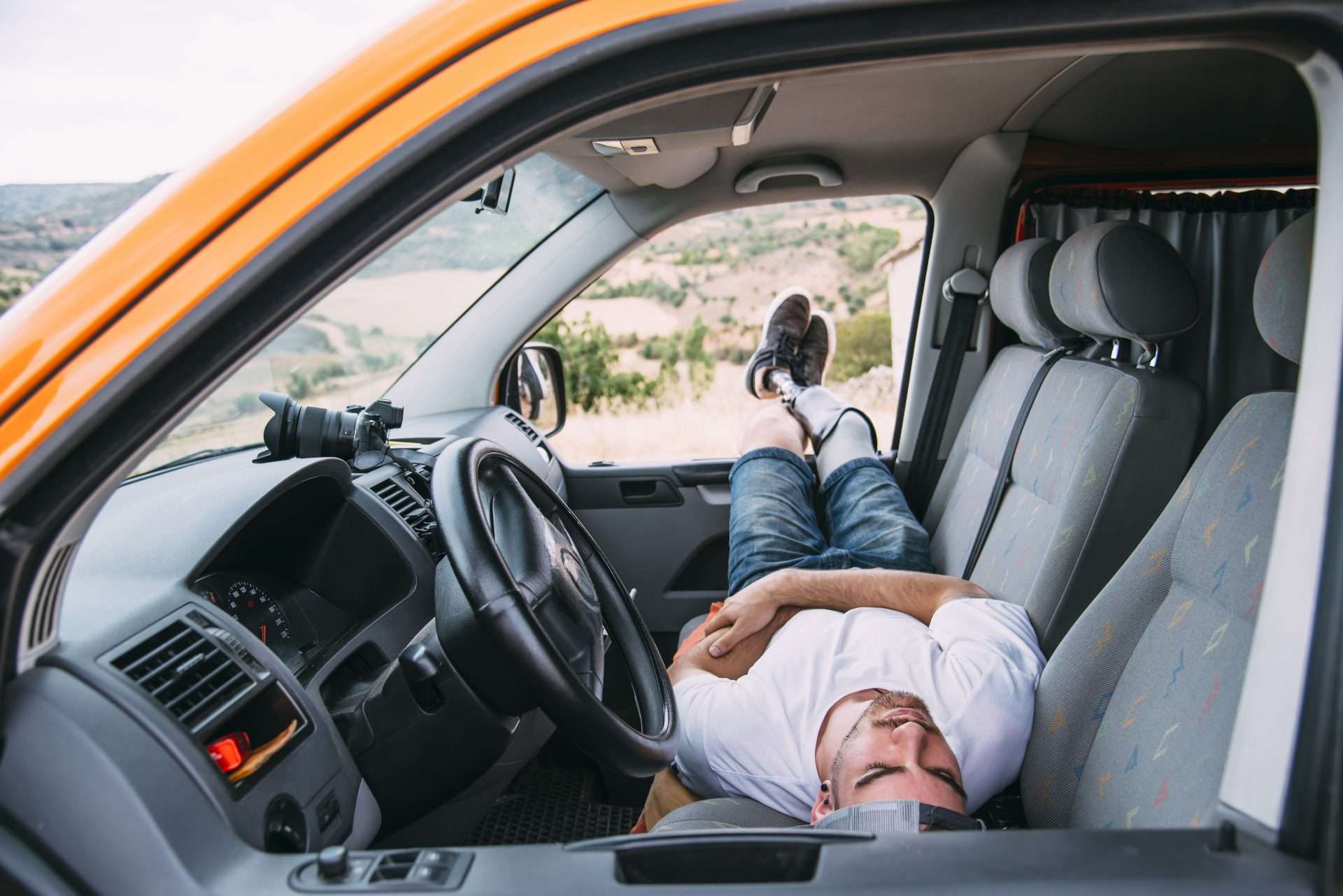 Man sleeping in the front of a U-Haul