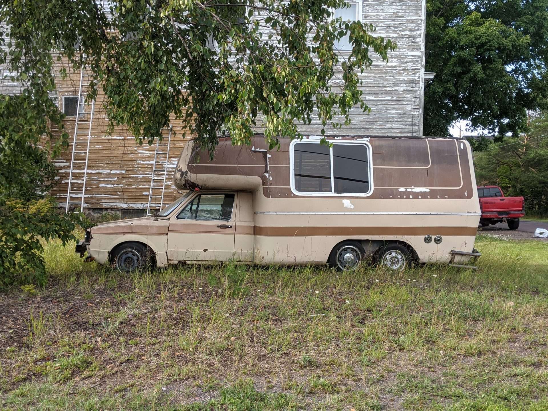 Old RV rusted in the grass