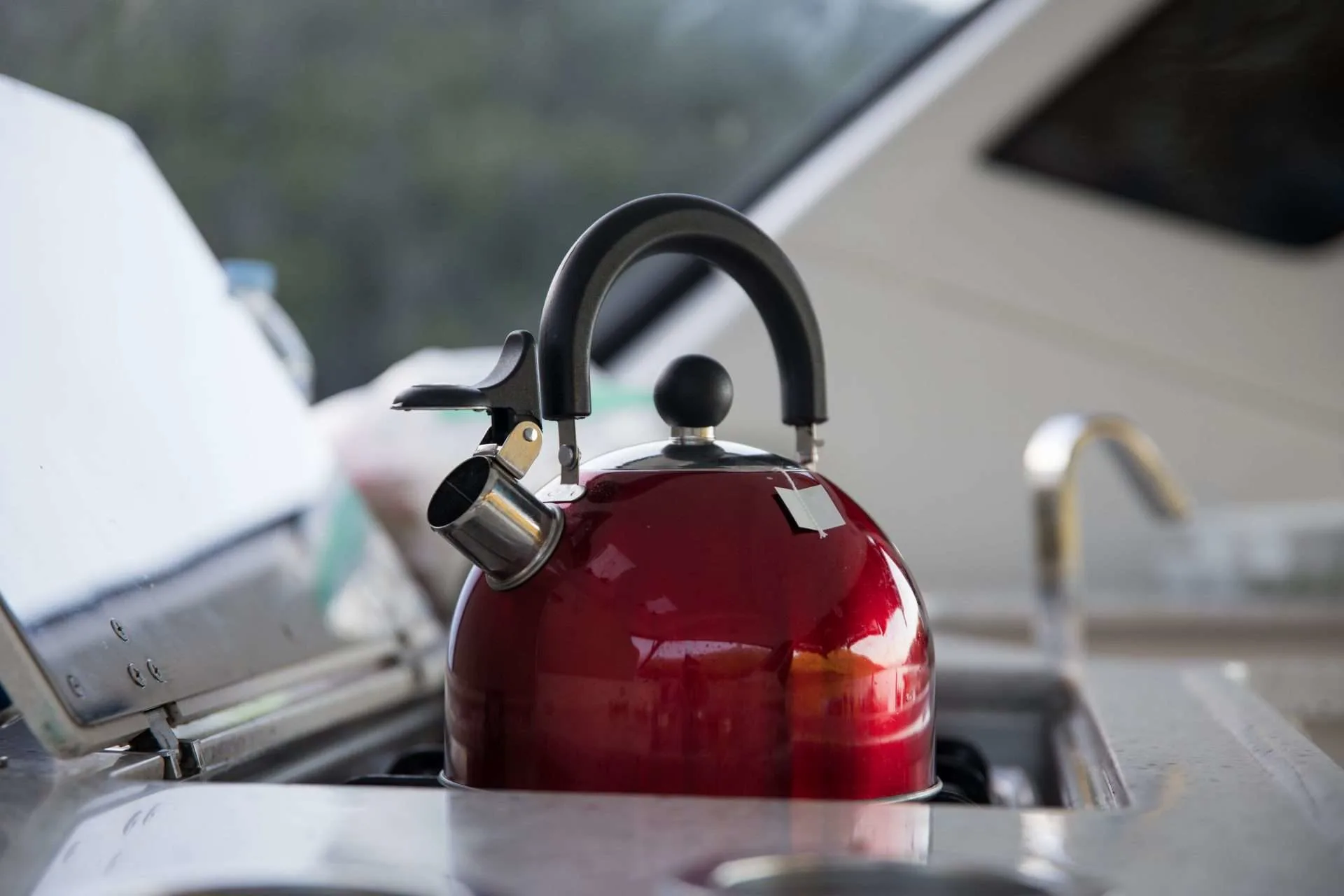 Close up of kettle boiling water on camper stove