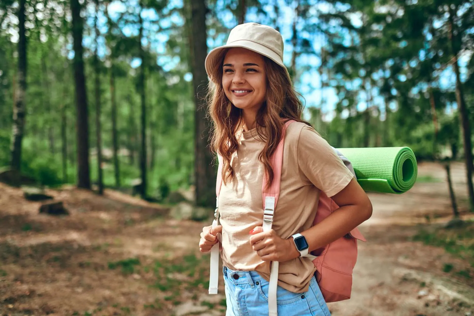Girl wearing hiking hat while hiking on trail