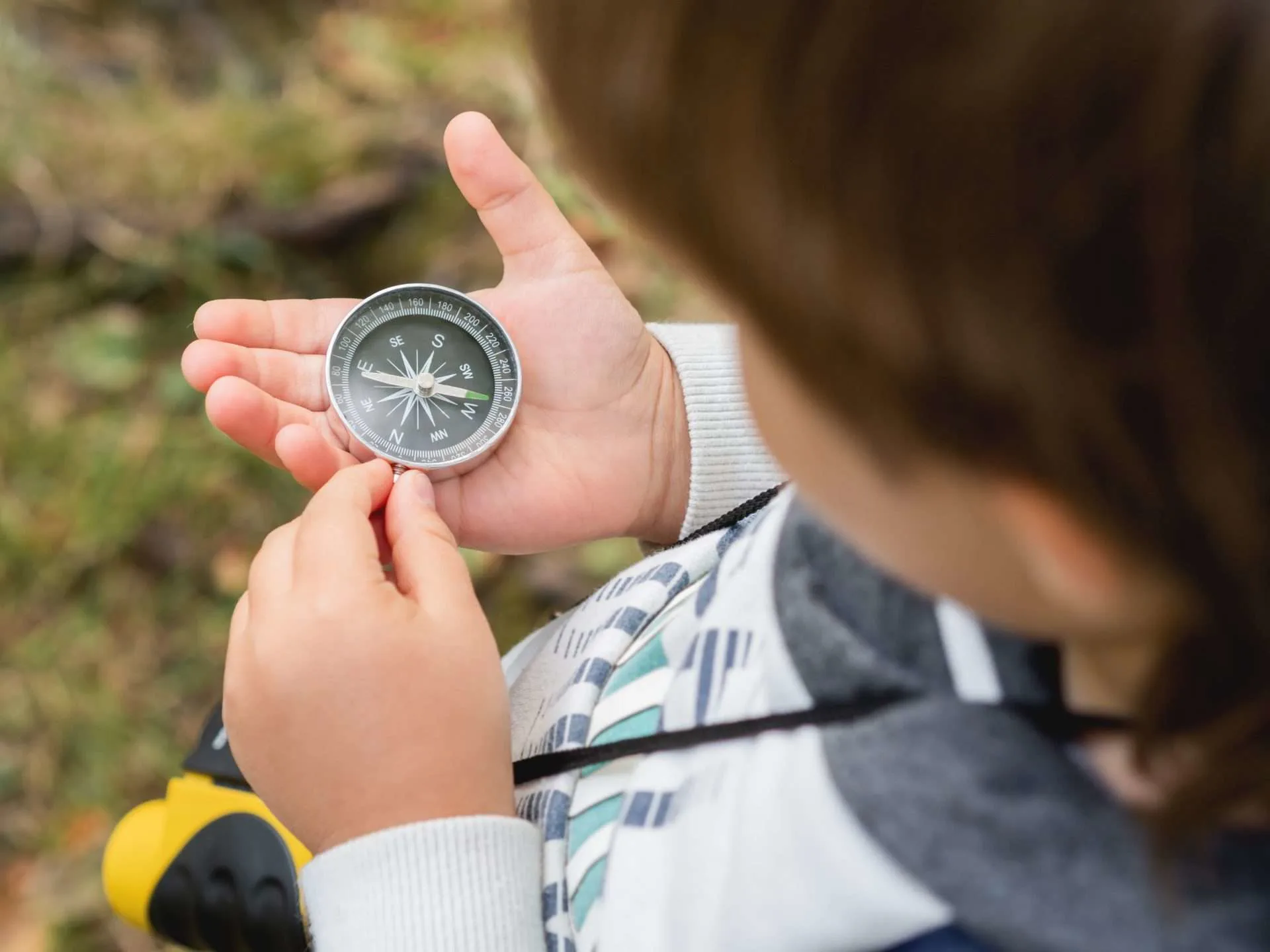 Little boy learning to use a compass