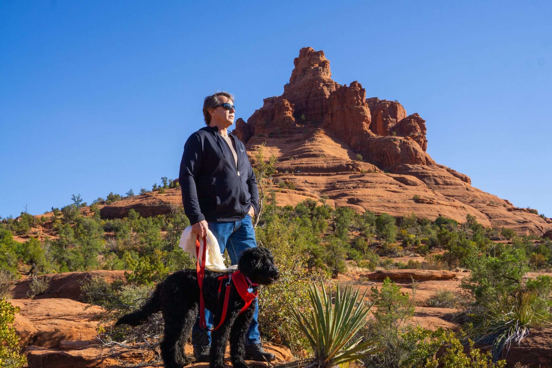 Man hiking with dog in Sedona, Arizona.