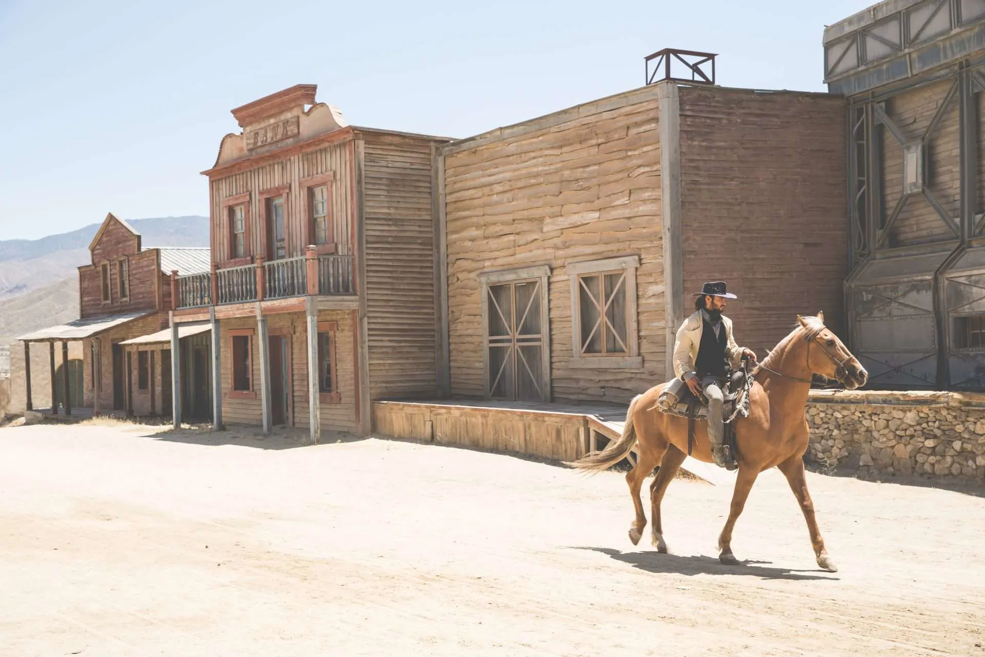 Man riding horse through ghost town