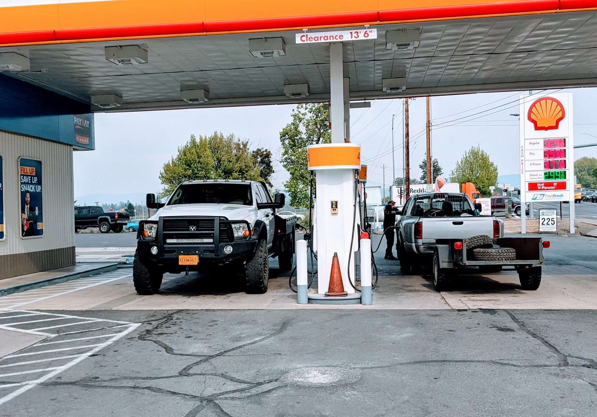 Trucks parked at gas station refilling car with gas without ethanol