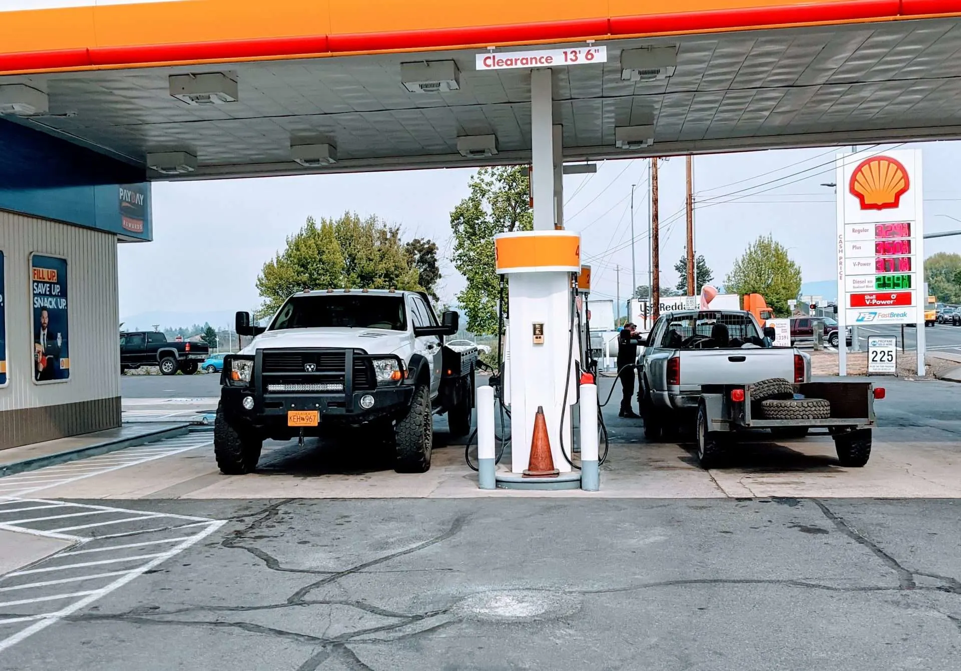 Trucks parked at gas station refilling car with gas without ethanol