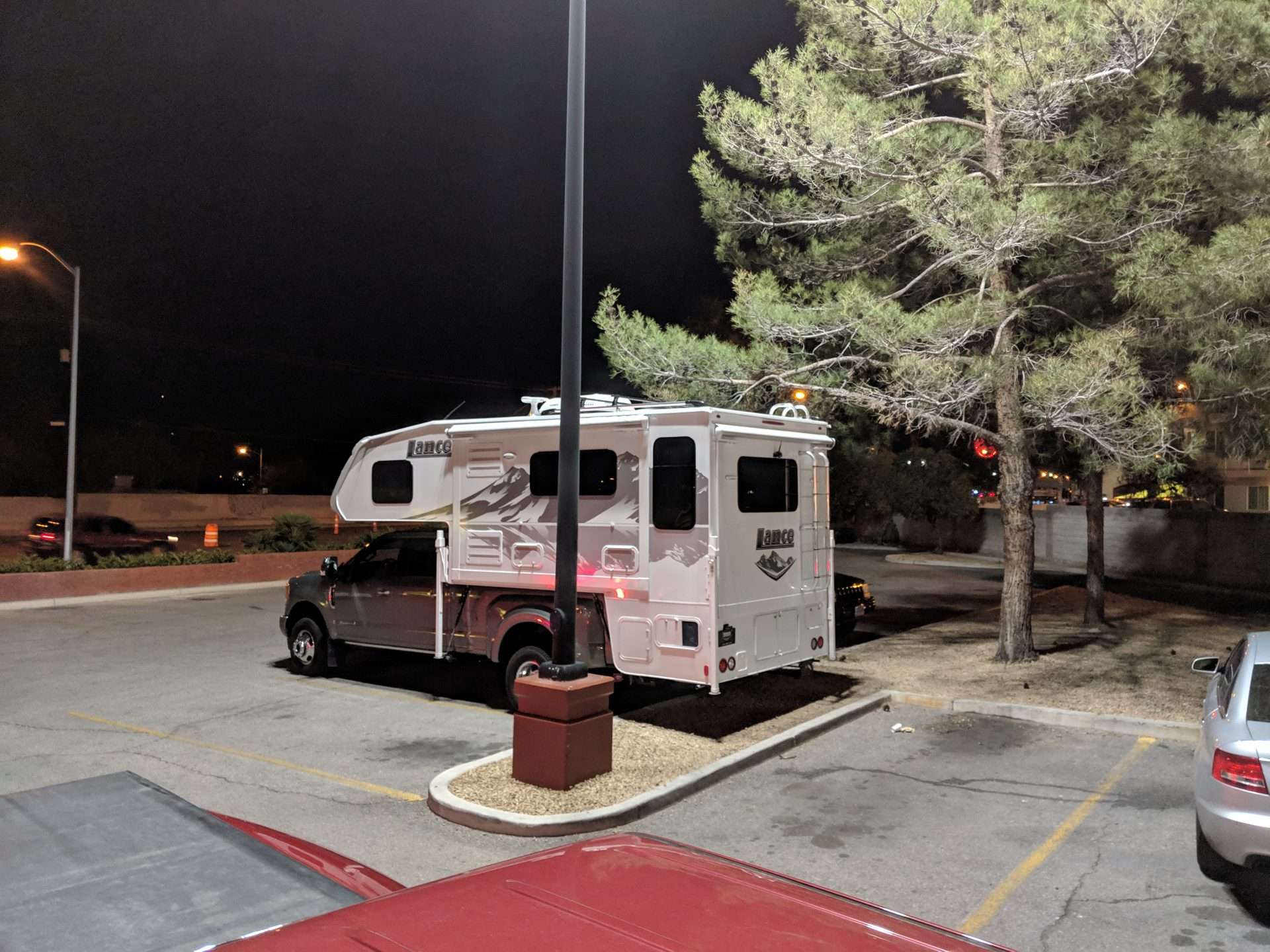 Truck camper parked in parking lot at night stealth camping in Florida