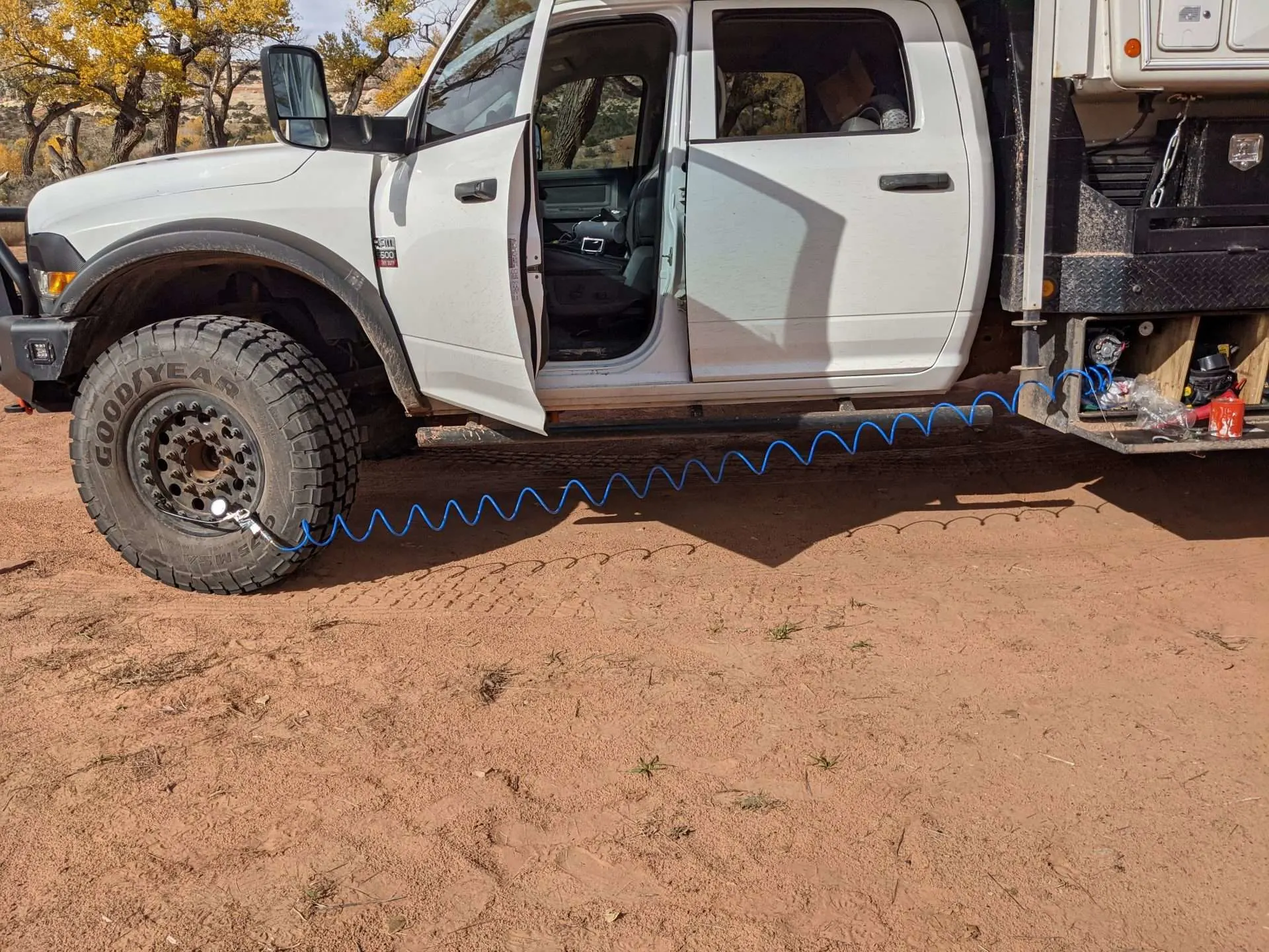 Tire deflator tool attached to tire while overlanding