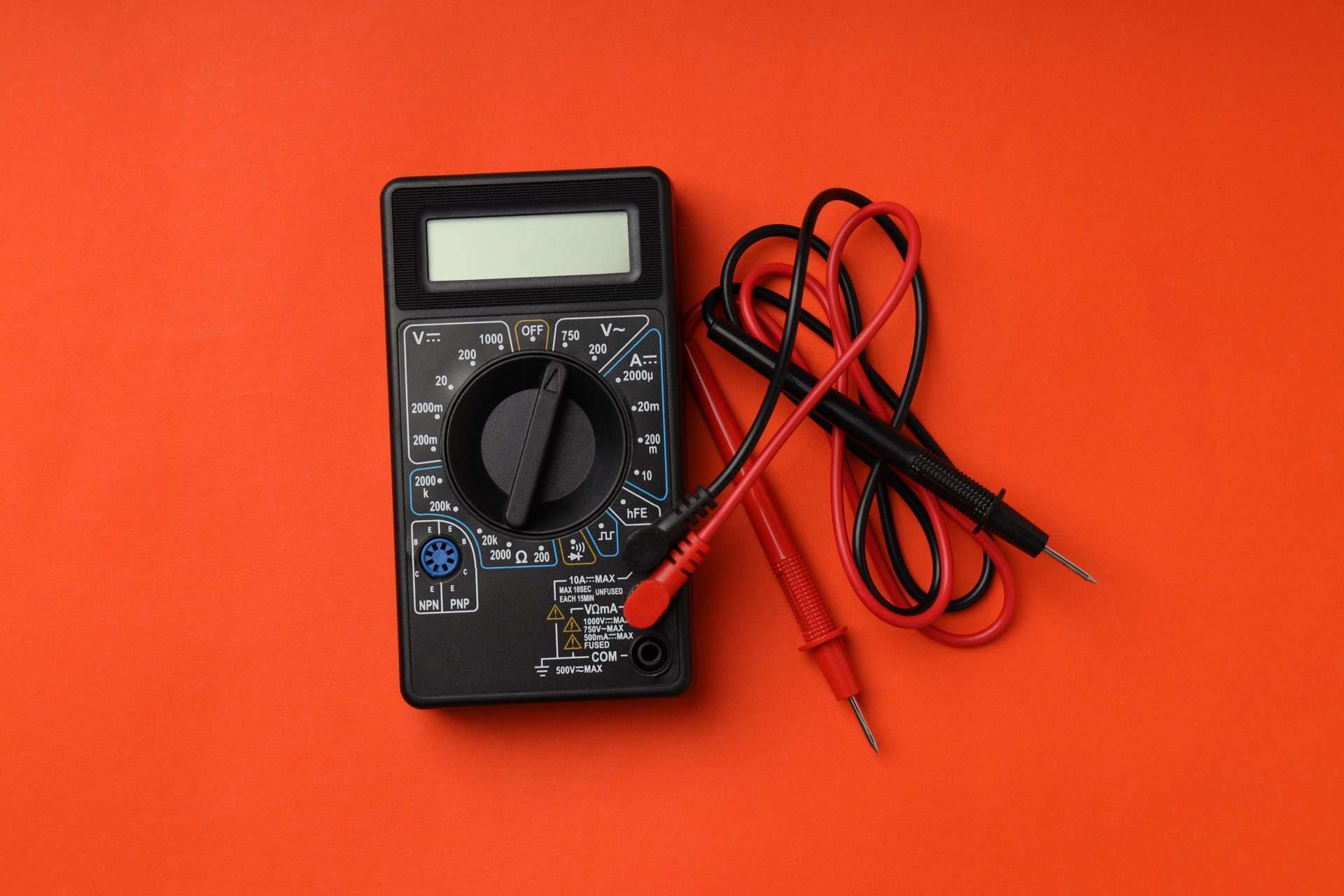 Multimeter on red background