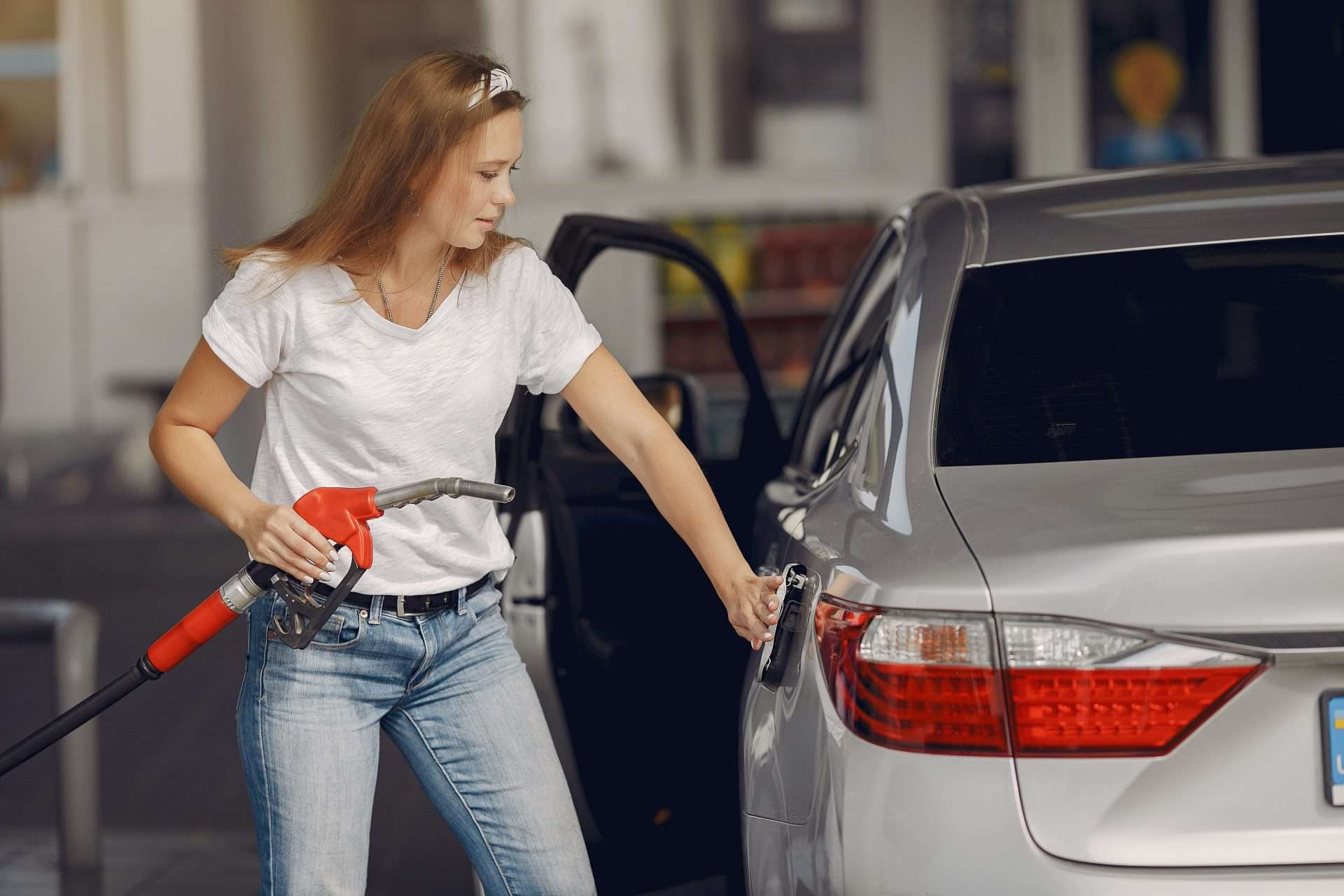 Woman refilling car with gas that doesn't have ethanol