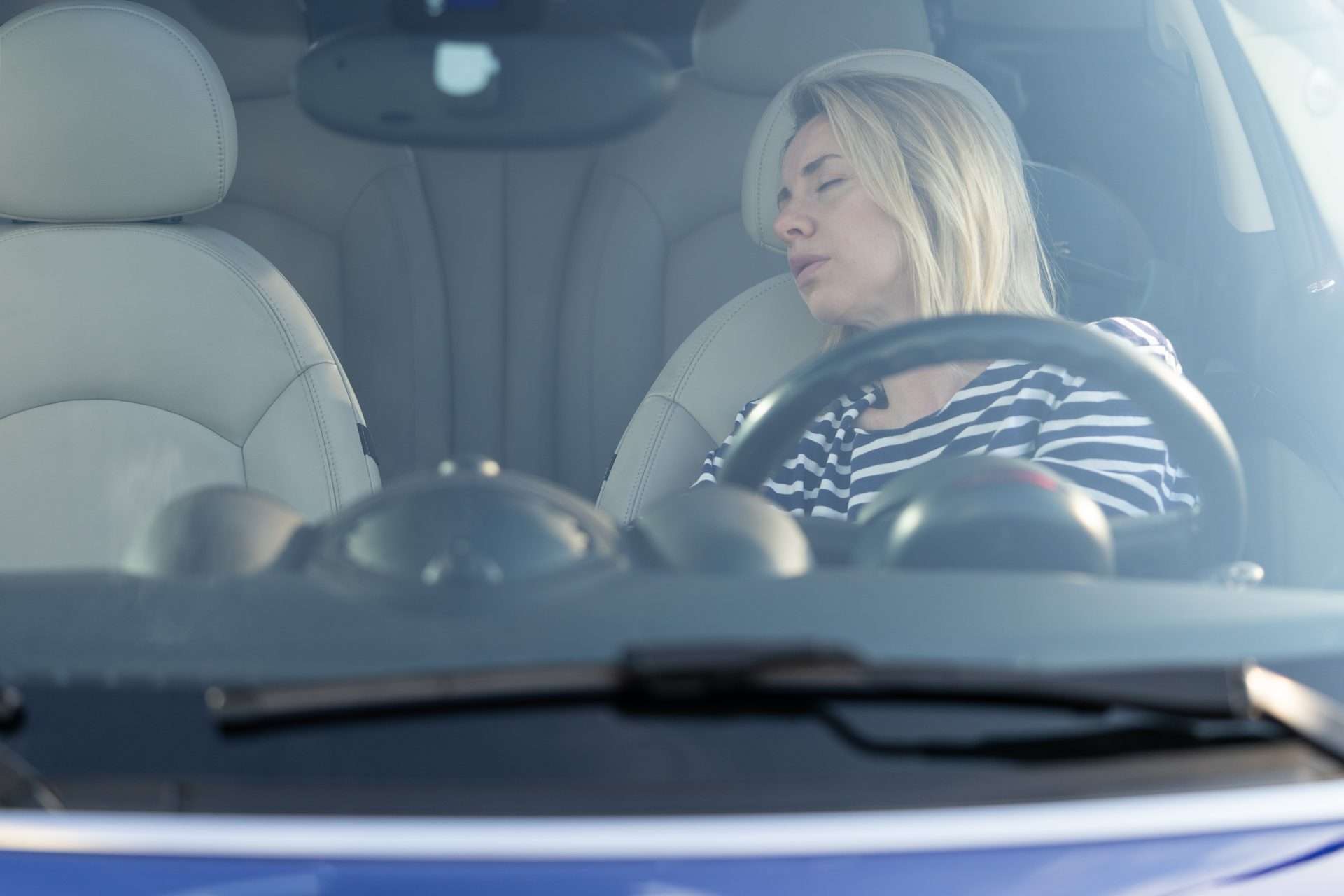 Woman sleeping in her car