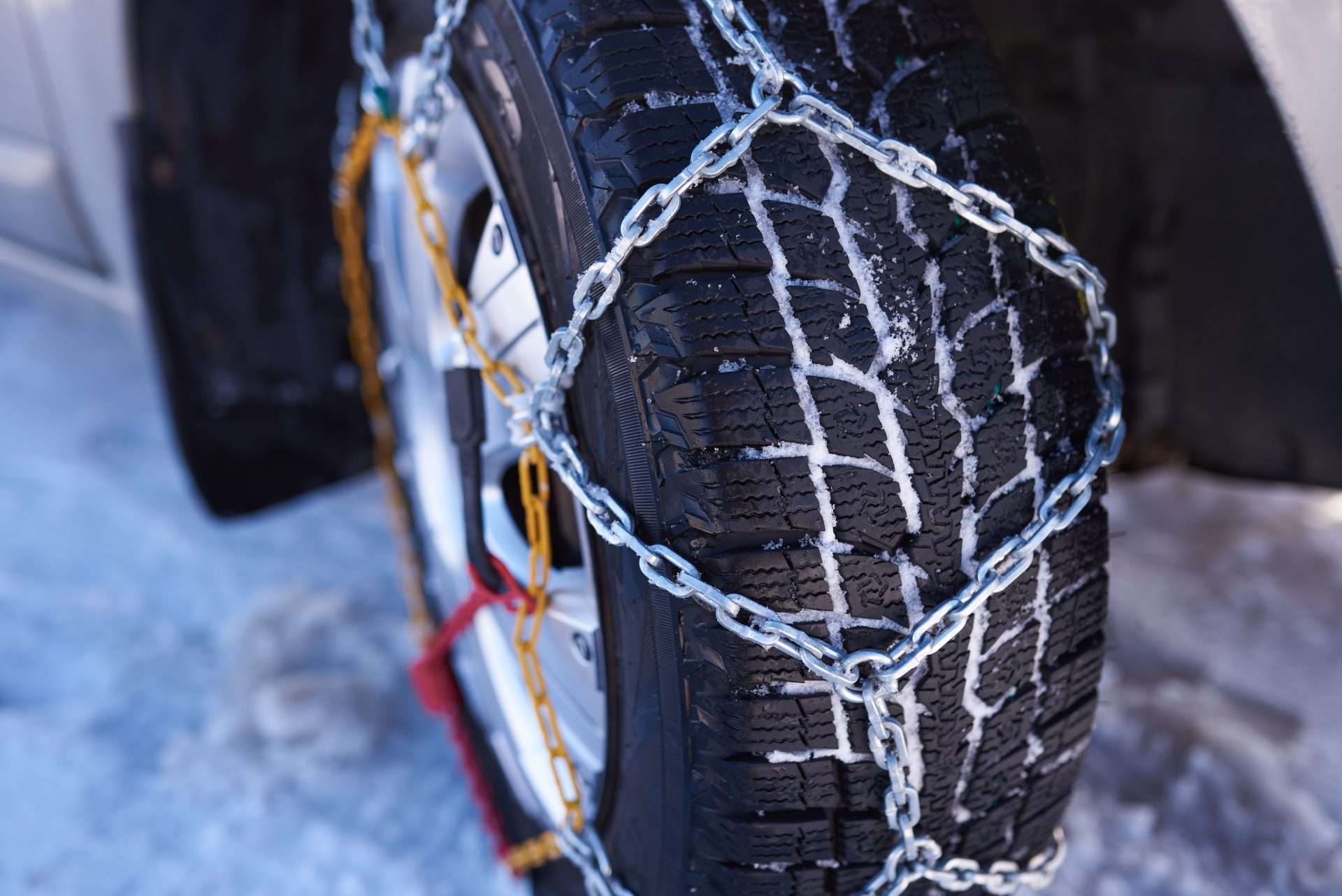 Close up of installed snow chains on tires