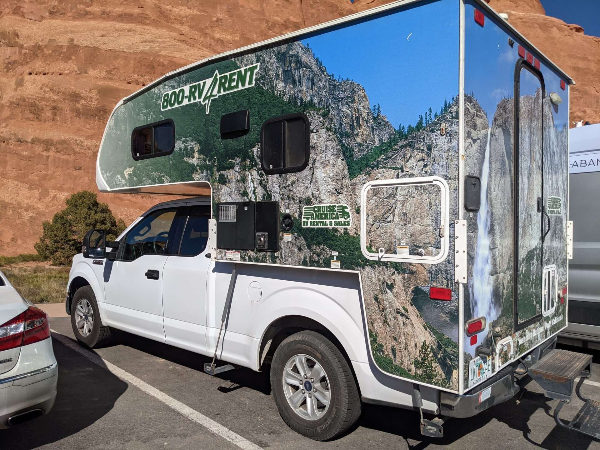 Truck camper for rent in parking lot