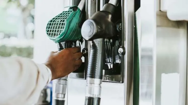 Person refilling gas at gas pump