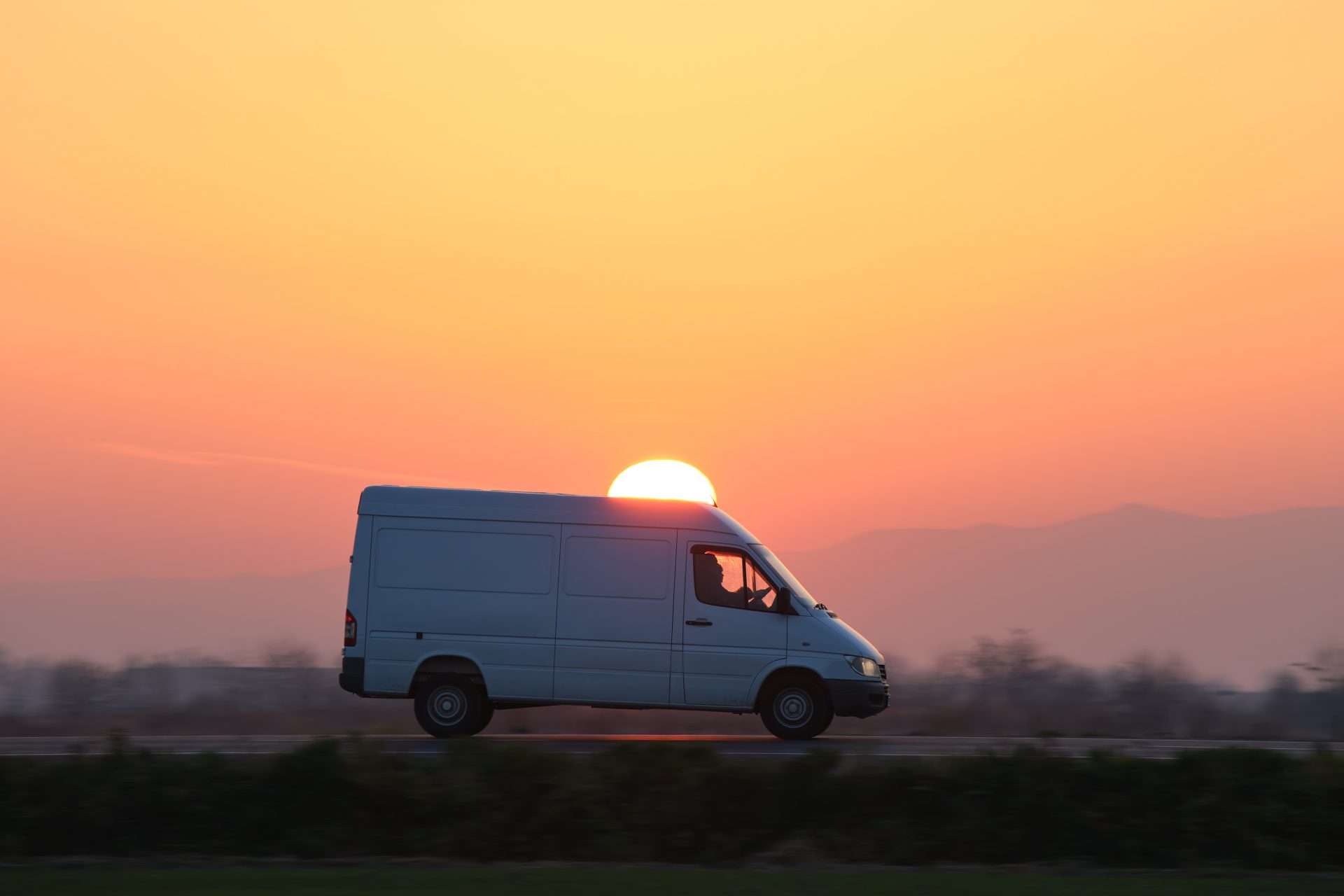 Ford Transit van driving on highway at sunset