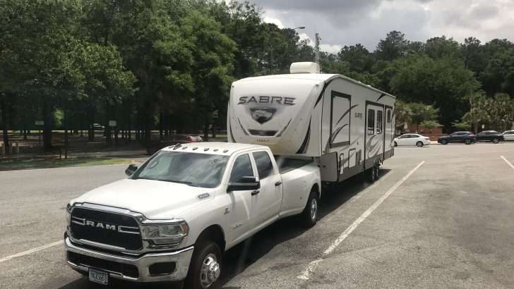 Truck hitched to RV parked in rest stop parking lot