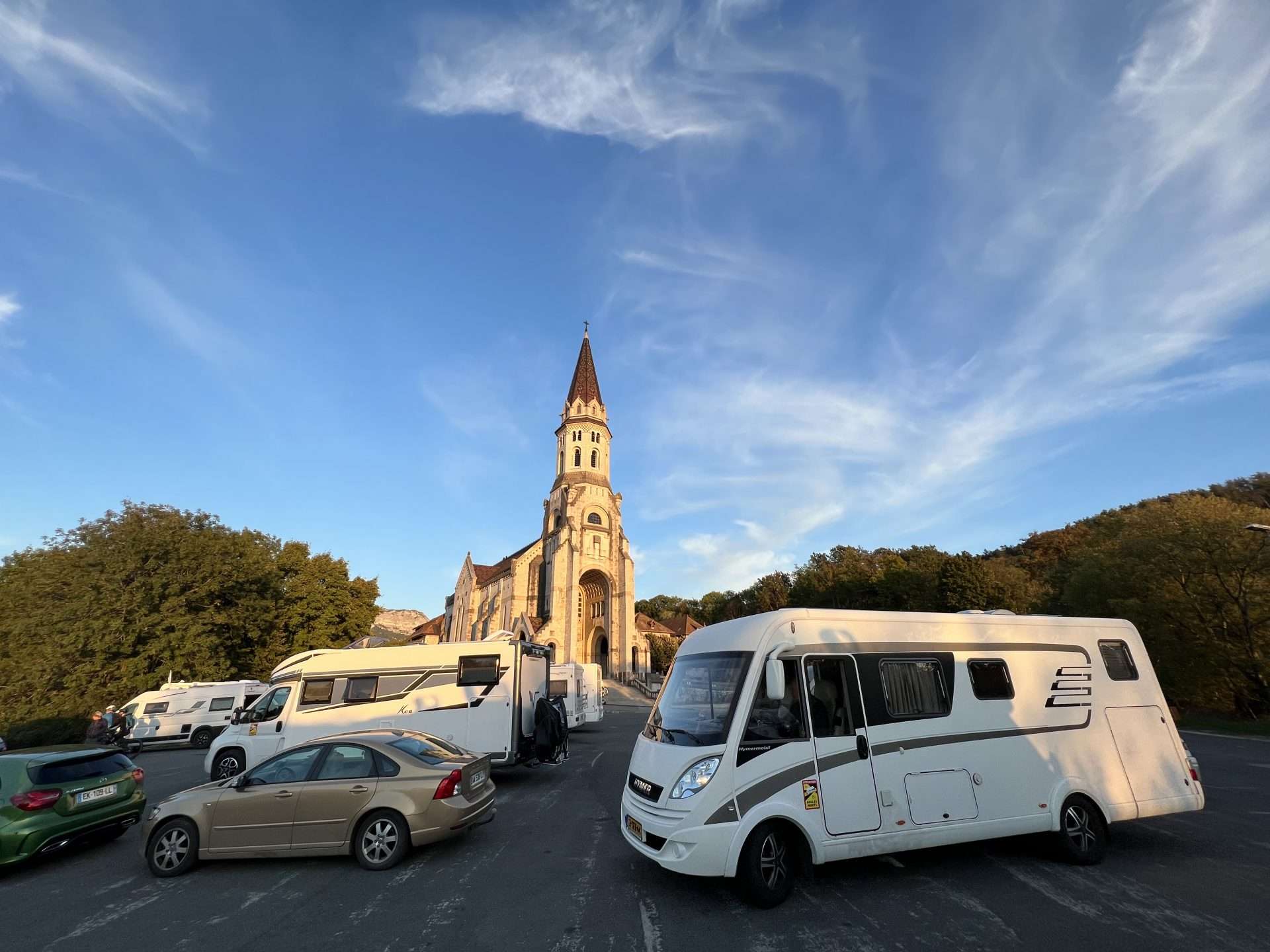 RV parked in front of a church in Europe