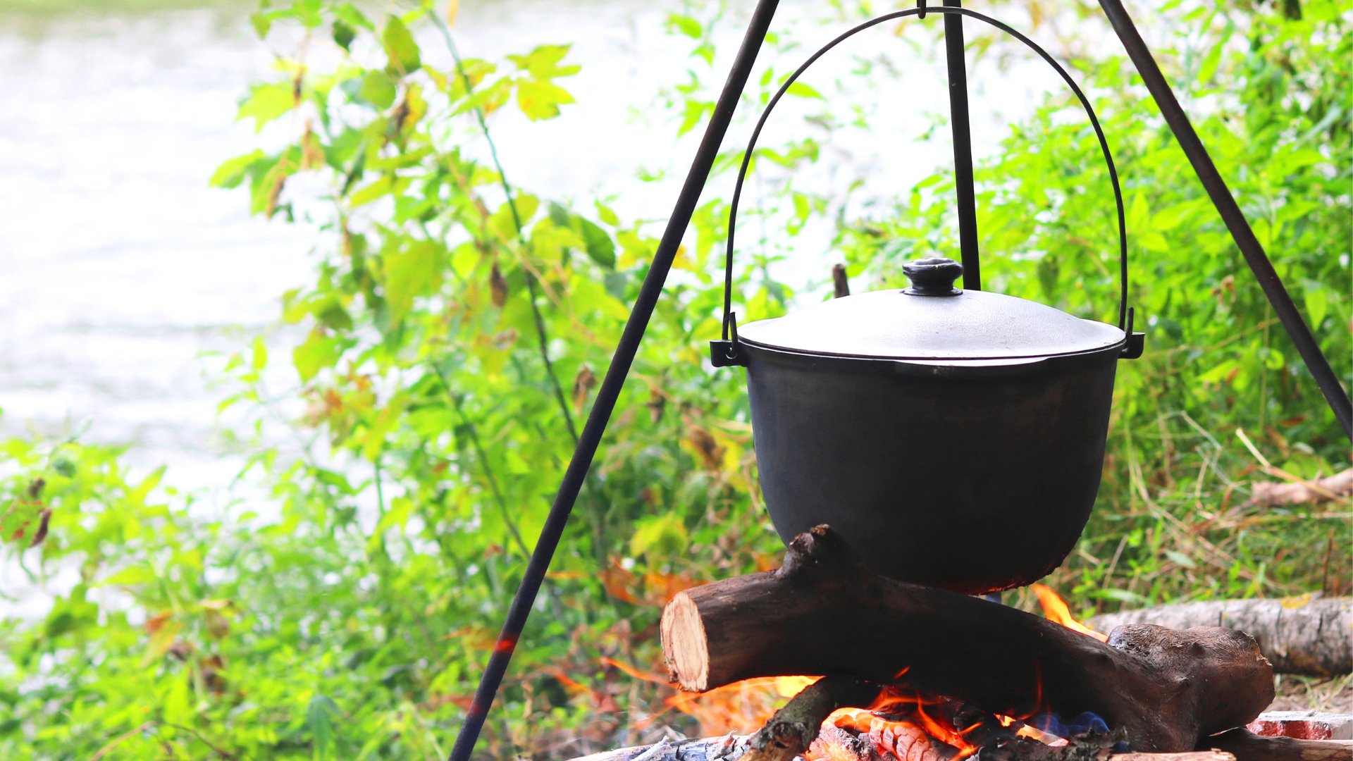 Campfire tripod with pot on it cooking