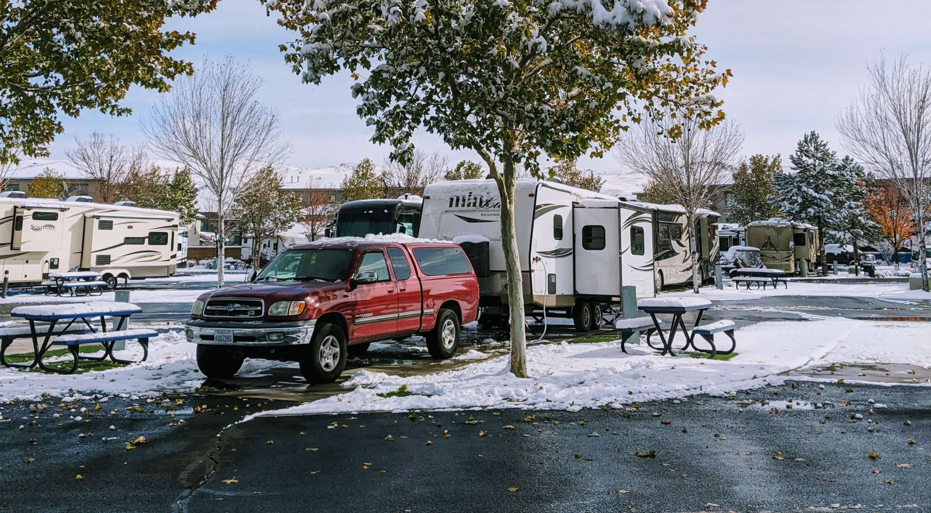 Fifth wheel RV parked in snow camping spot