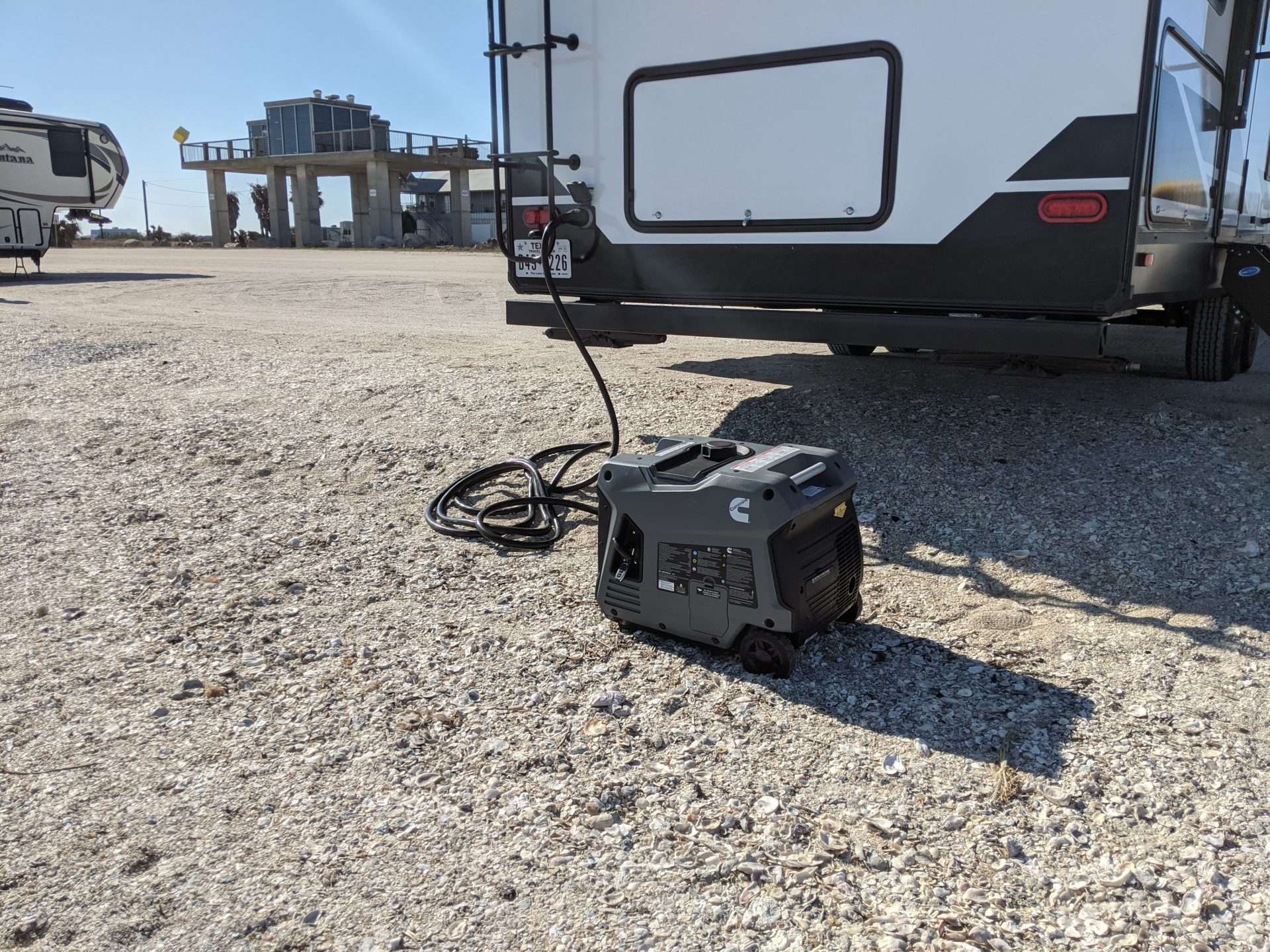 RV at campsite with generator plugged in