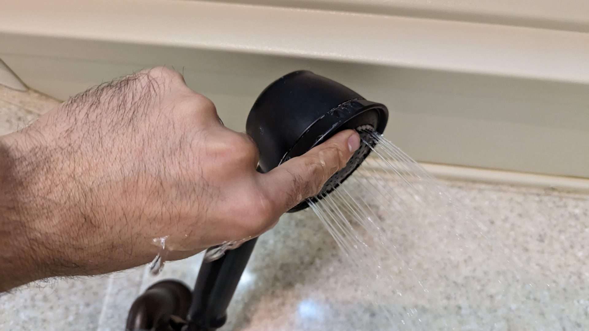 massaging a shower head 