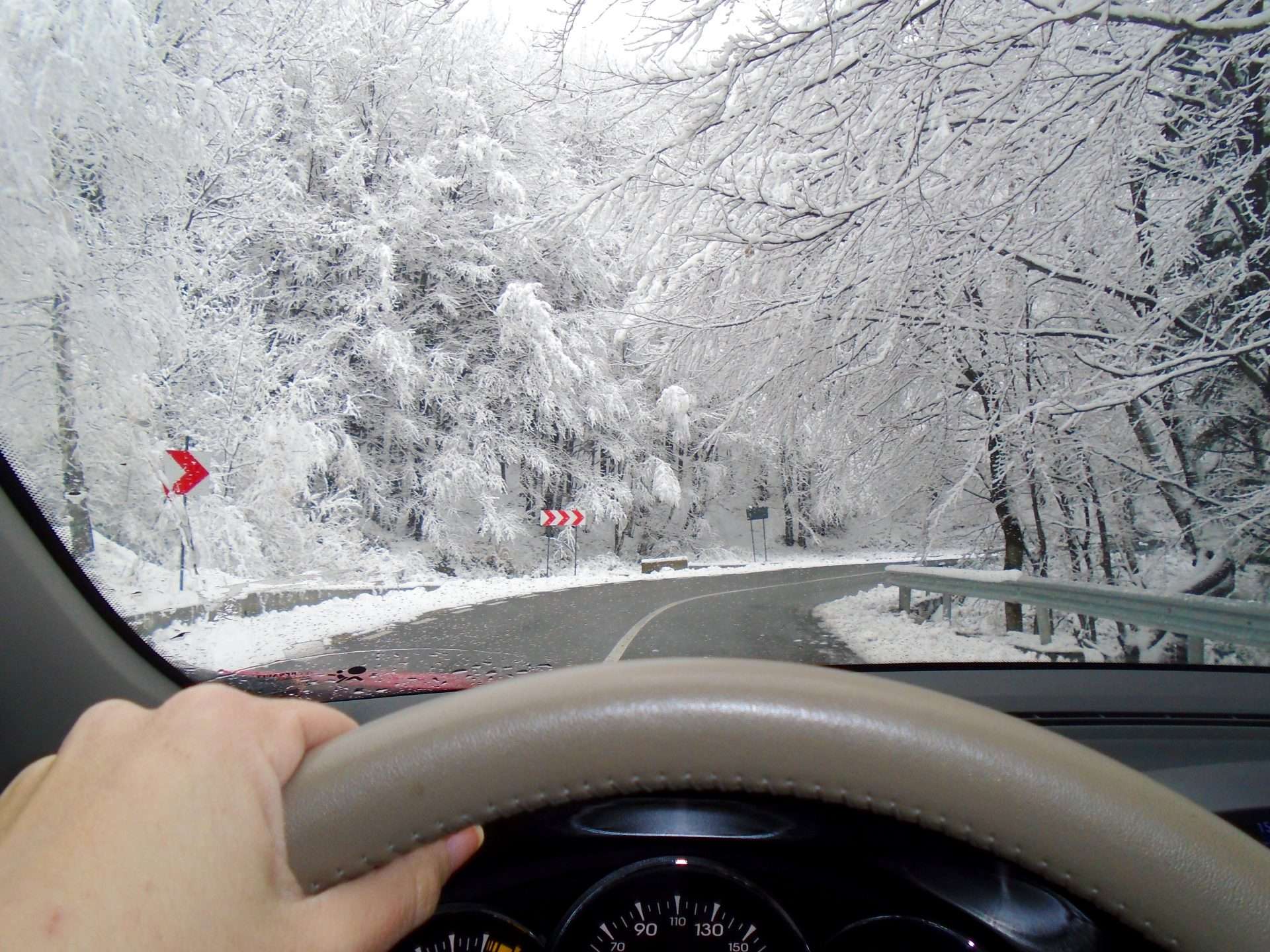 View driving down snowy road