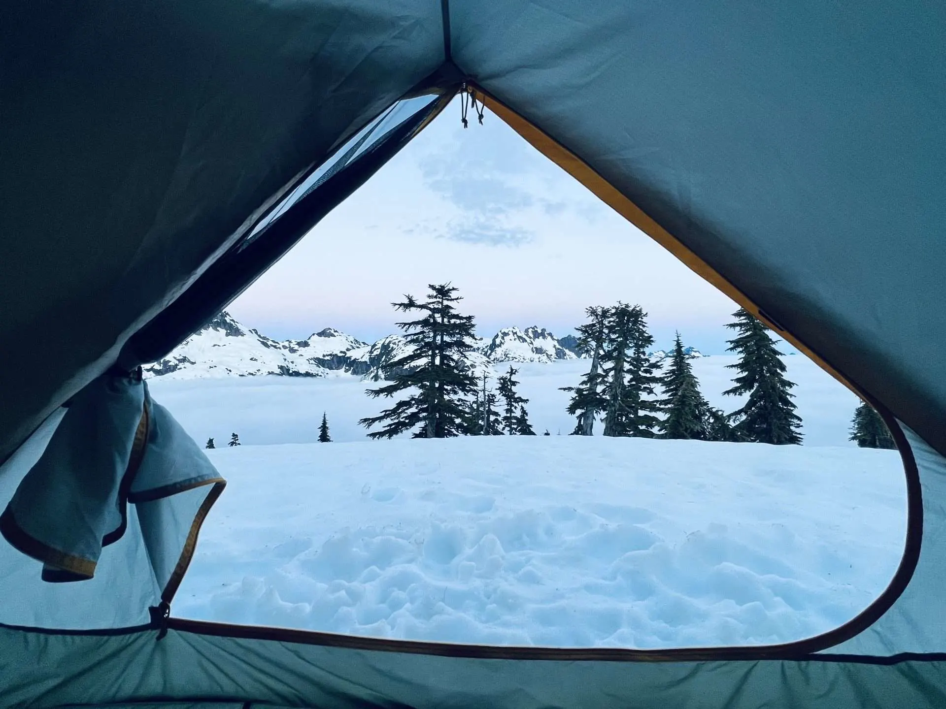 View looking out of tent to snow