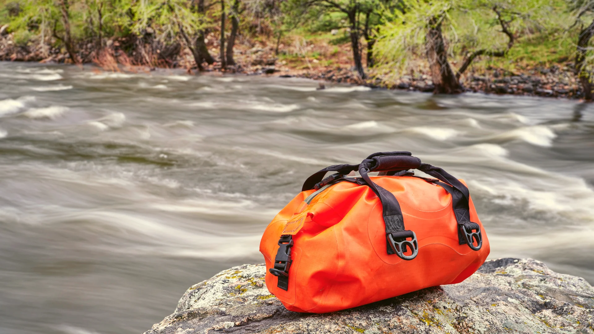 dry bag on rock by river
