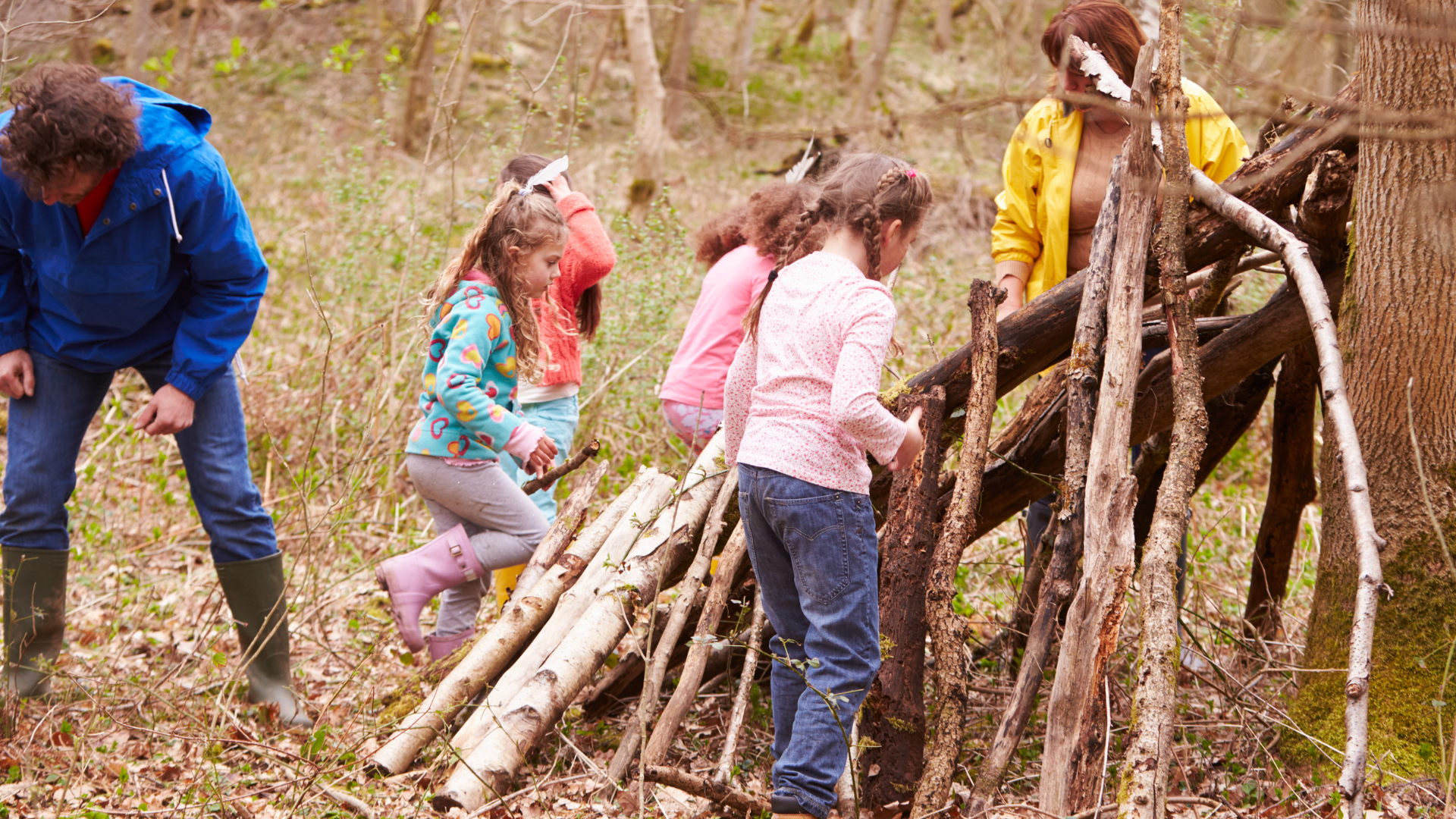Kids learning how to build bushcraft shelter