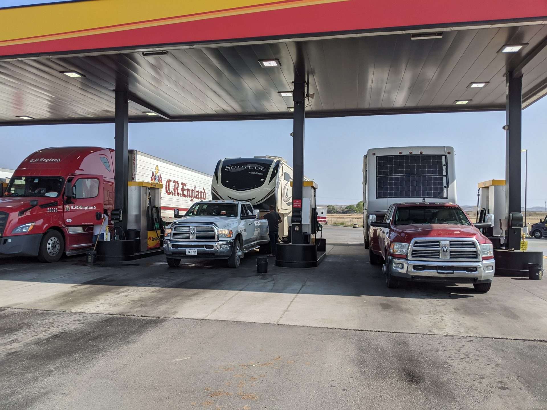 Fifth wheel RVs refueling at gas station