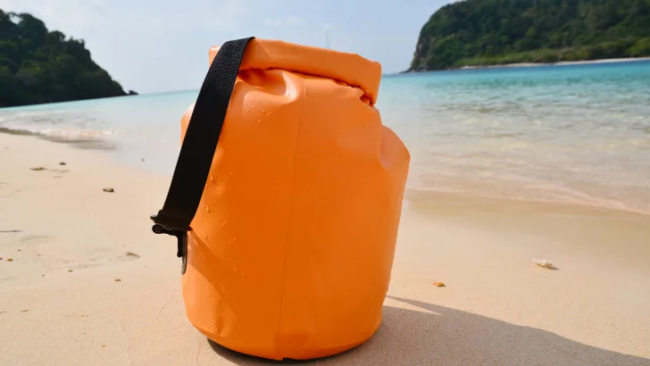 Dry bag packed next to ocean