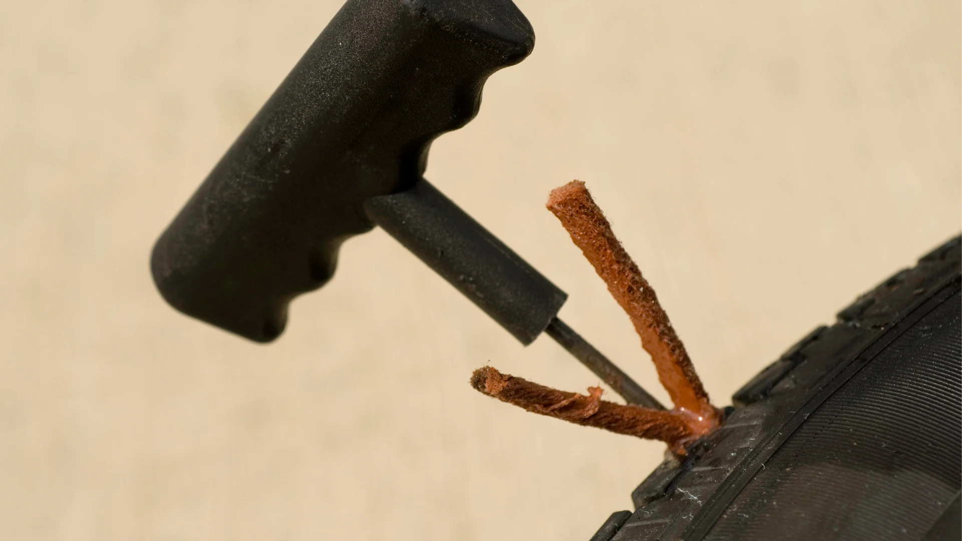 close up of plugging a tire