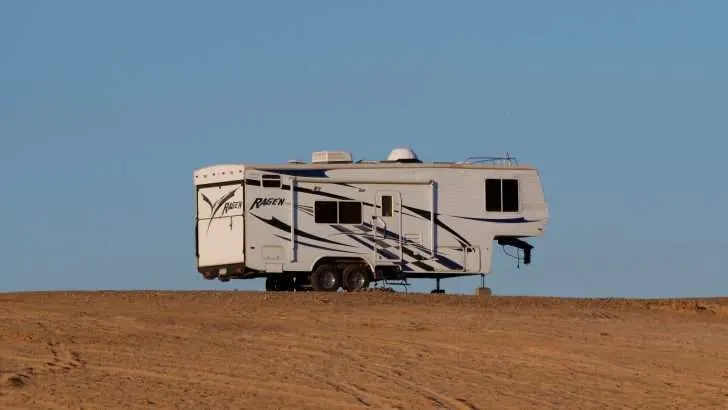 RV parked in desert with auto-leveling system