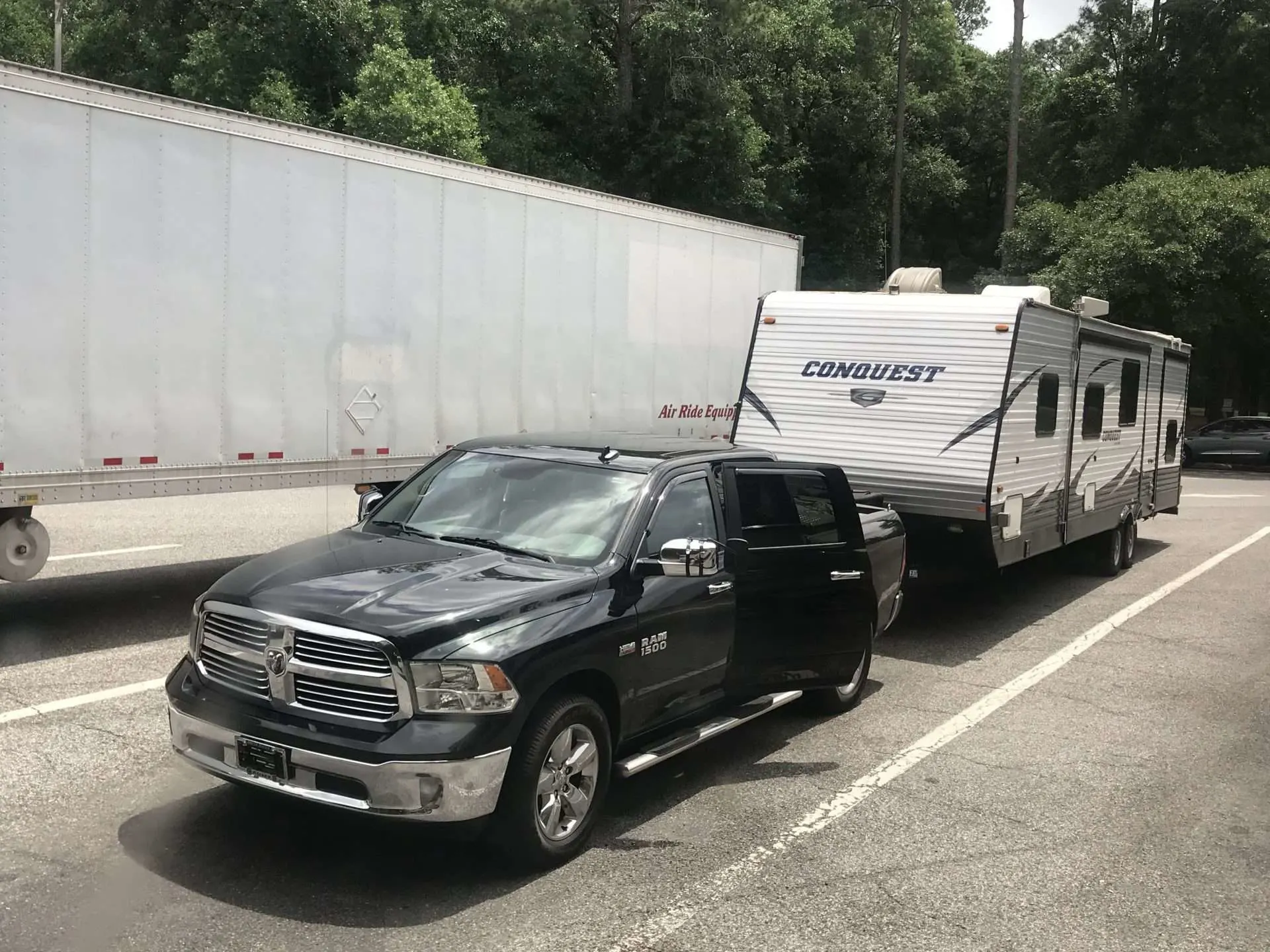 RV parked next to truck at rest stop