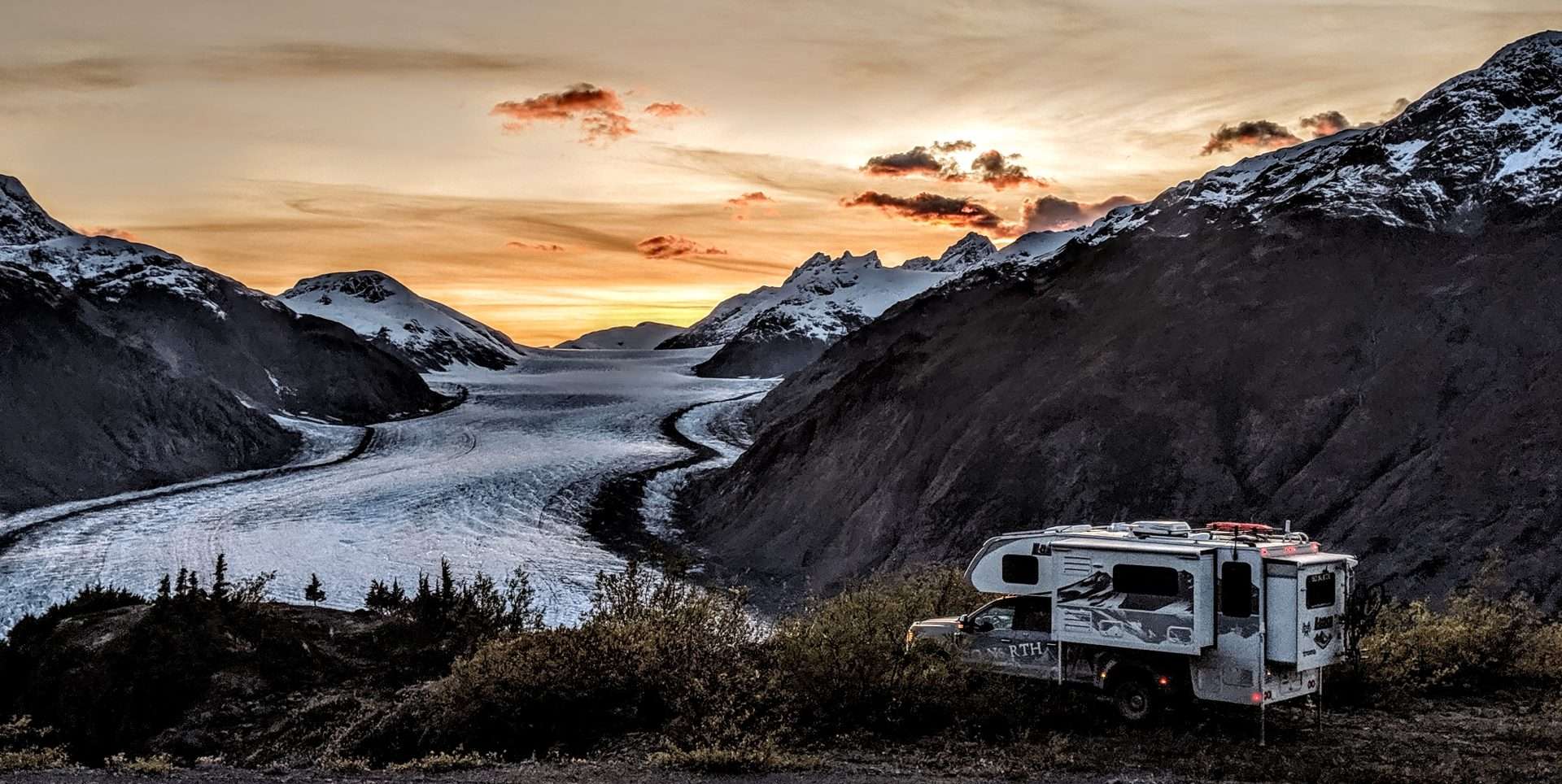 Camper parked in Alaska at sunset
