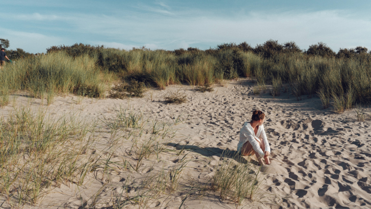 Woman sitting in dunes along National Lakeshore