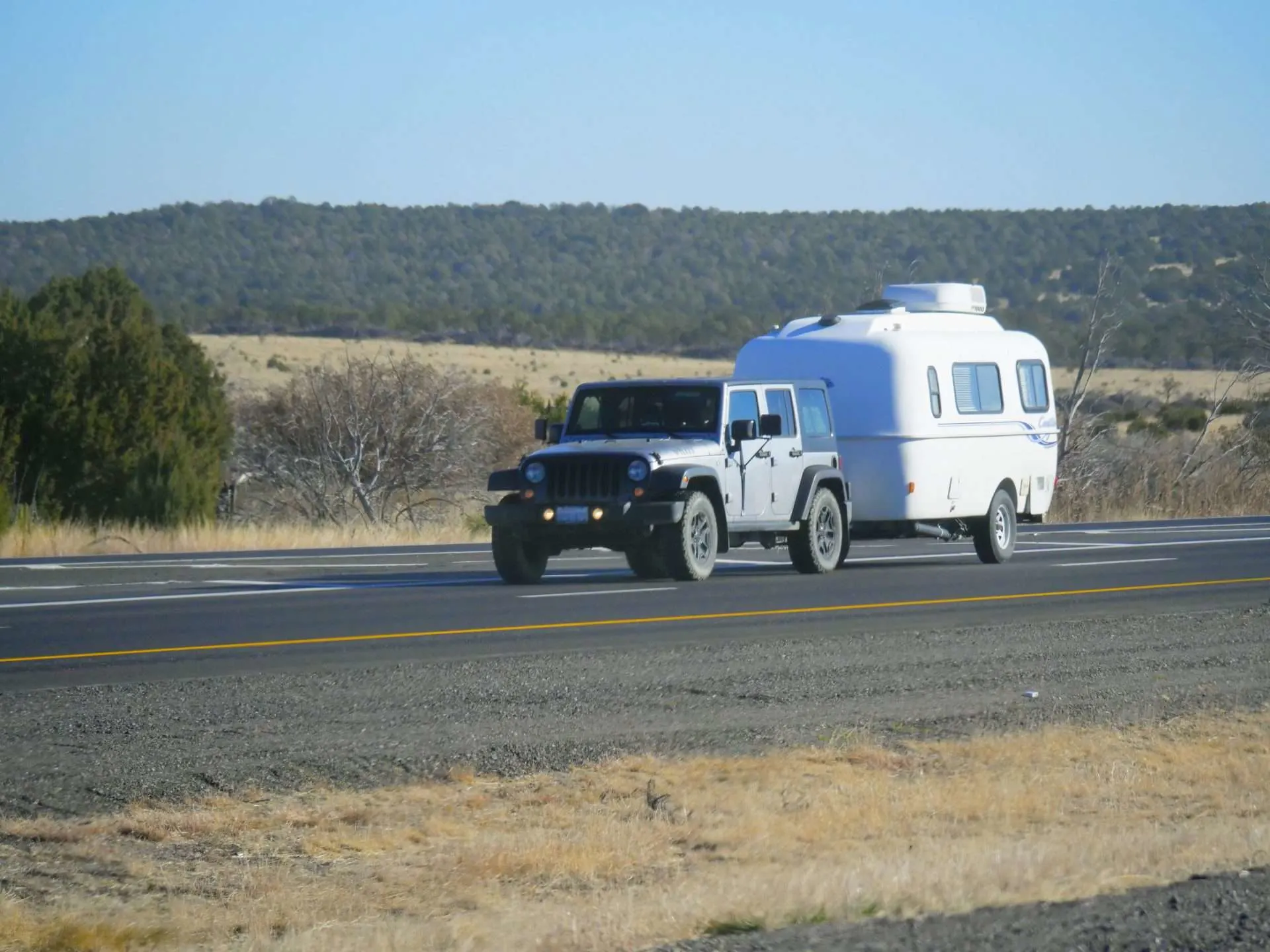 Jeep Wrangler towing a pull behind camper