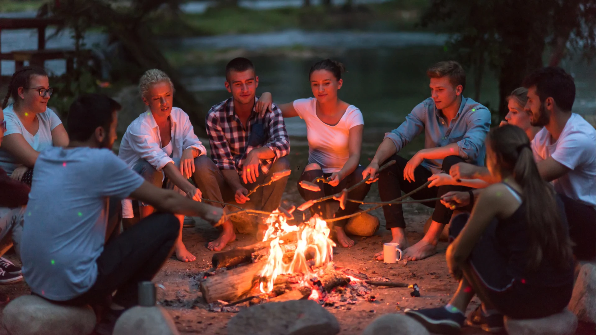 Adults playing campfire drinking games