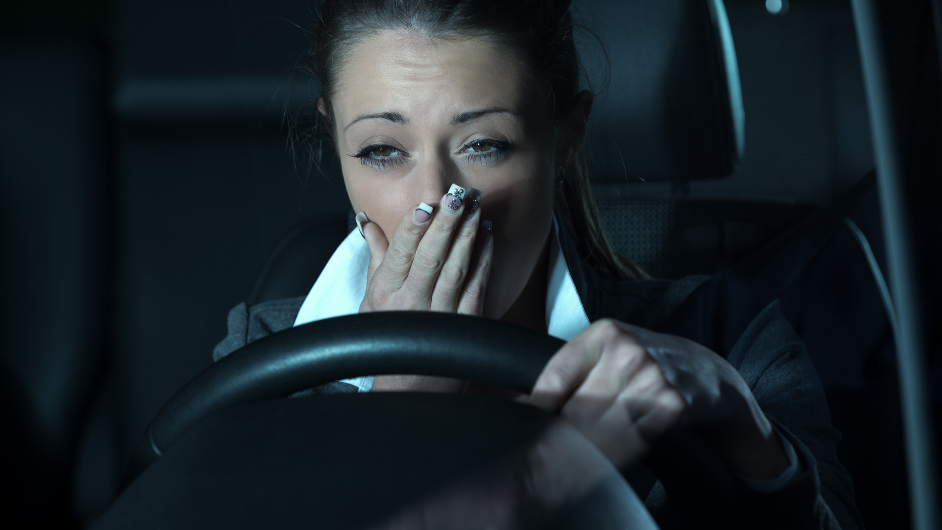 Woman tired while driving at night