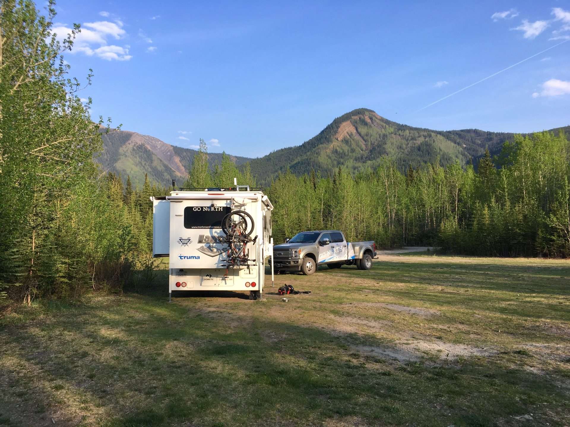 Stable truck camper at campsite by mountains