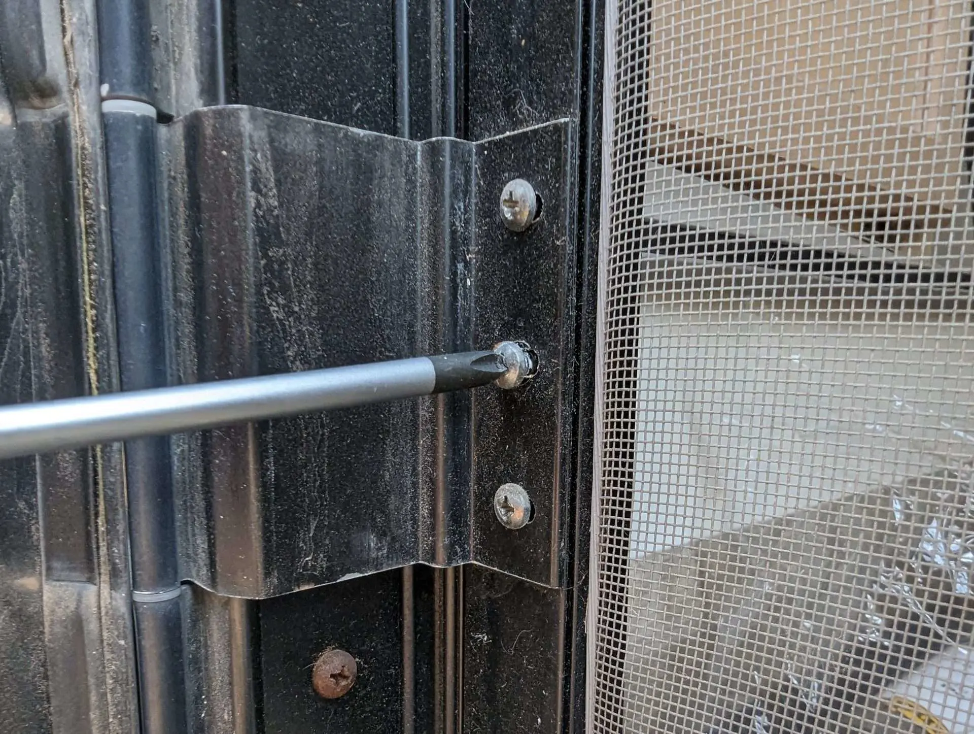 unscrewing an RV screen door to replace it