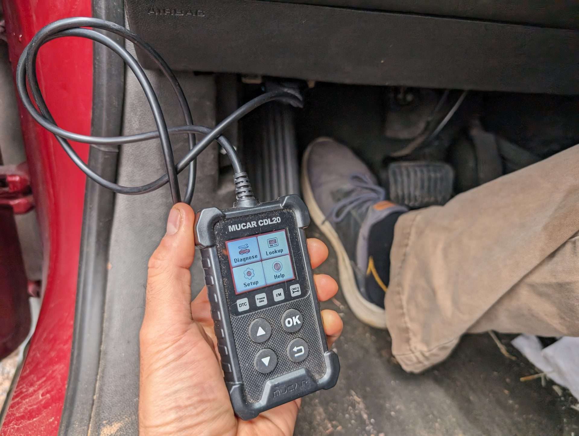 cheap obd scanner plugged into car