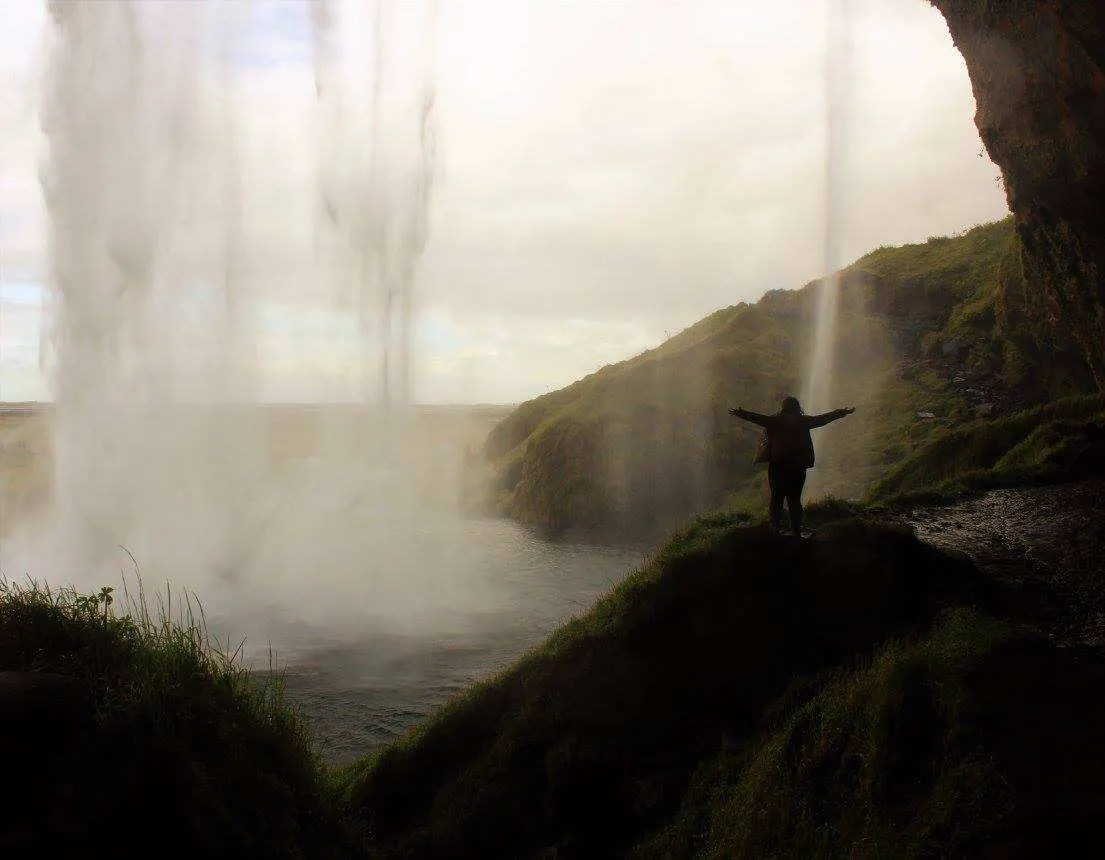Walking behind a waterfall in Iceland