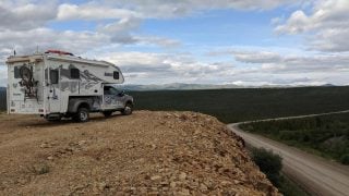 Truck camper overlooking dirt road